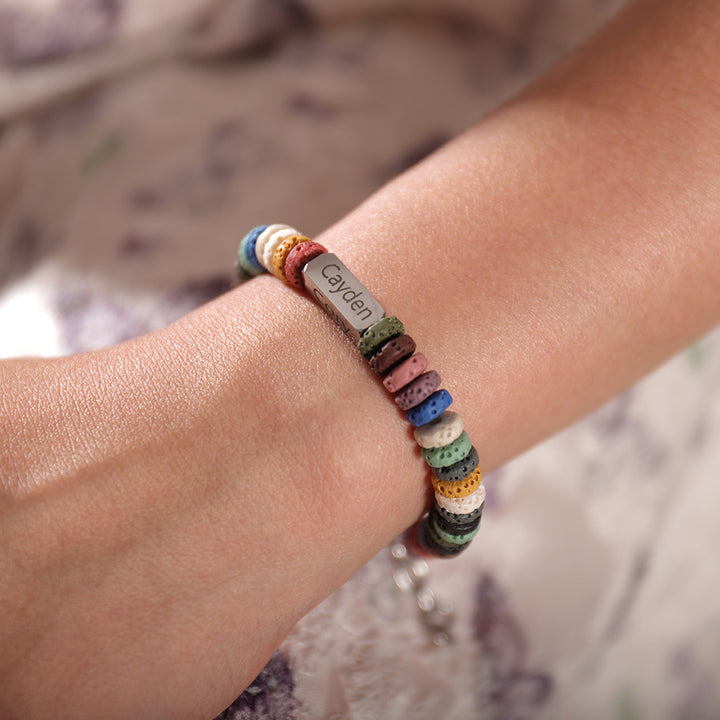 Close-up of black lava stone bracelet with engraved names – meaningful gift