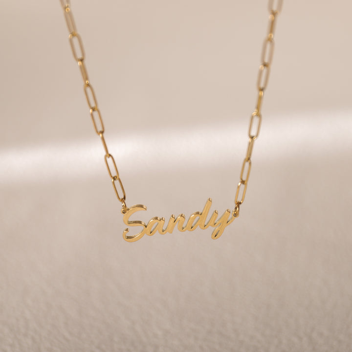 Close-up of name pendant on paperclip chain – trendy everyday jewelry