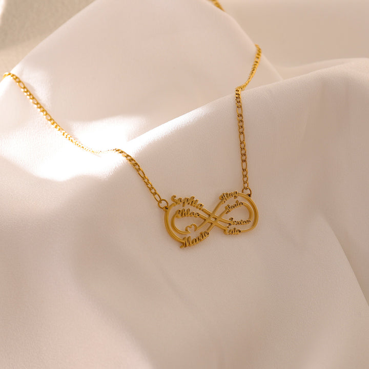 Close-up of nameplate necklace with 3 names and heart accents