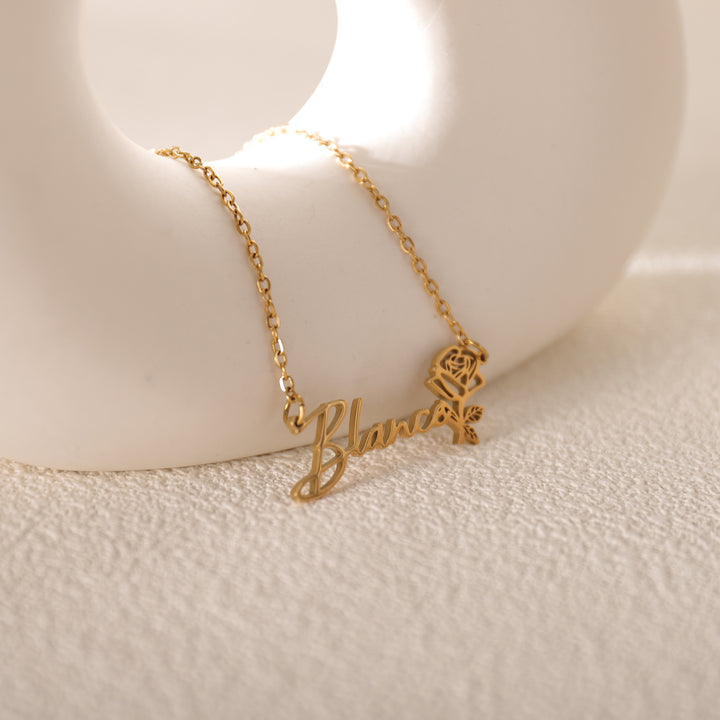 Close-up of personalized name and birth flower necklace details