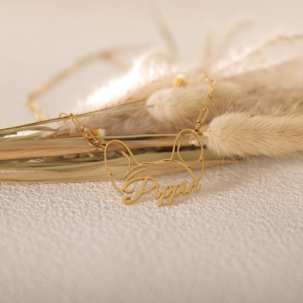 Close-up of personalized pet name pendant worn by woman