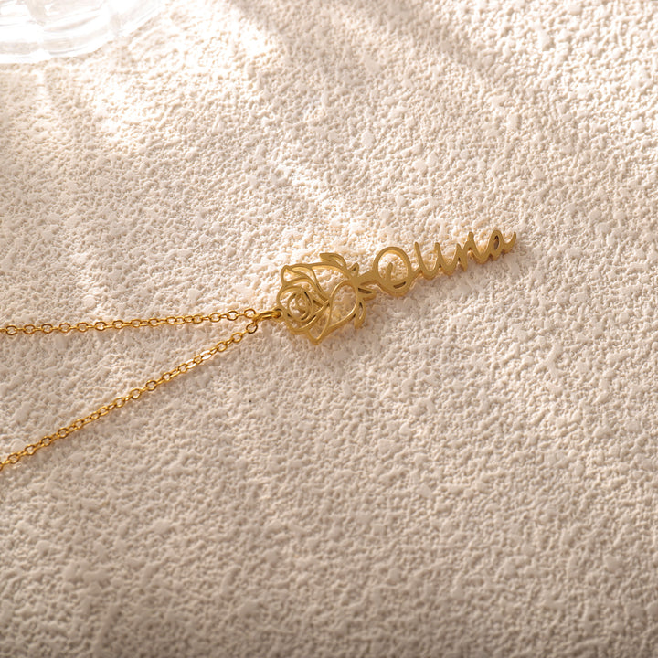 Close-up of rose name necklace with romantic floral engraving