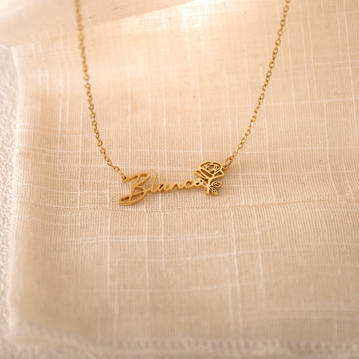 Delicate flower name pendant in rose gold on marble background