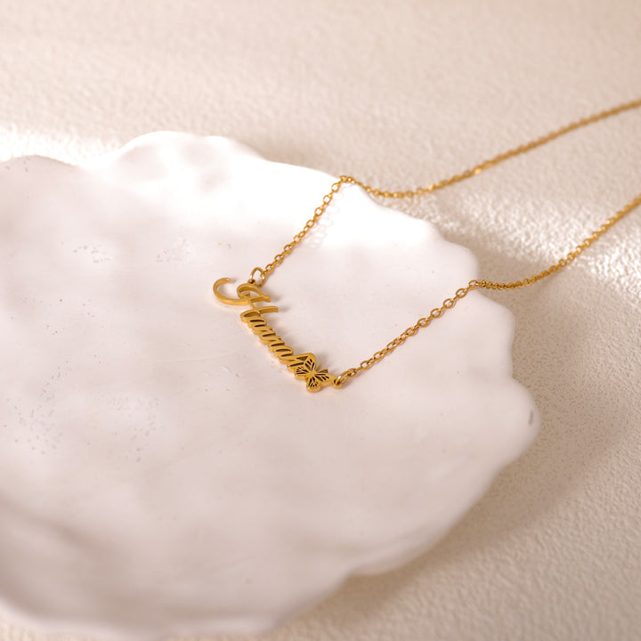 Gold butterfly necklace for mom – close-up of engraved name pendant