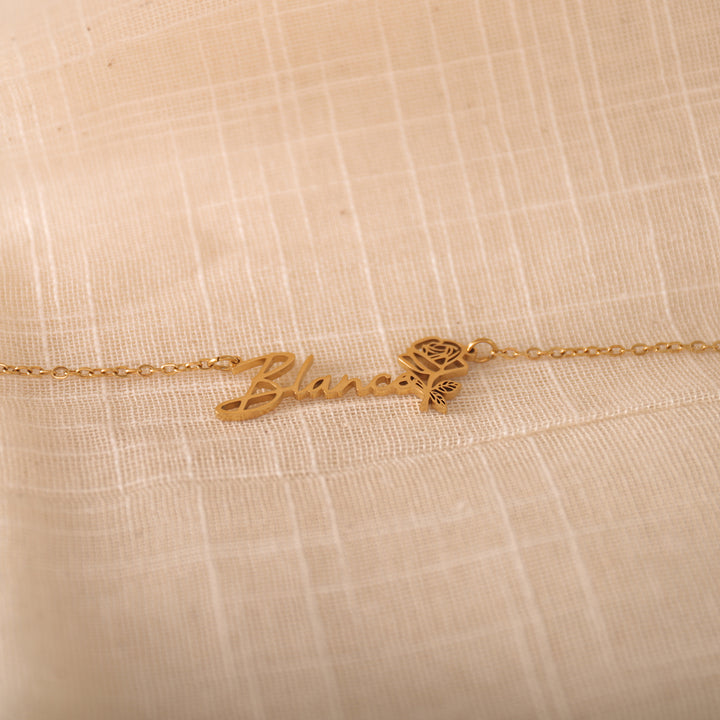 Personalized floral name necklace displayed on model's neck