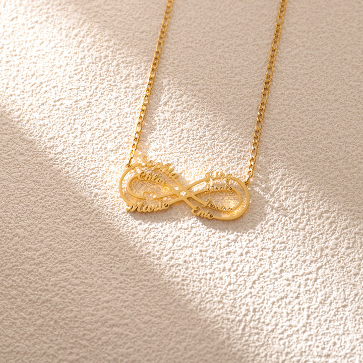 Personalized necklace with 8 engraved names, worn by woman in cozy outfit