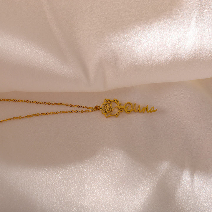 Personalized rose flower necklace worn by a woman in soft lighting