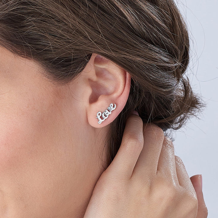 Rose gold curved name earrings styled with minimal outfit