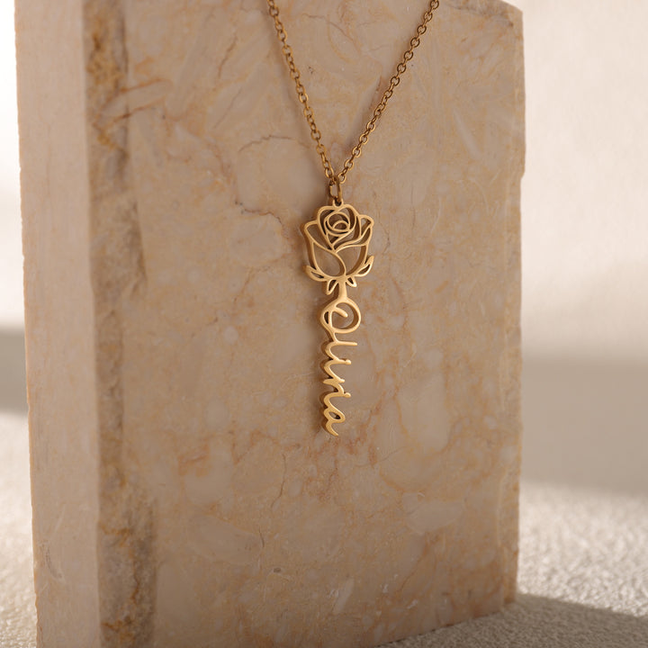 Rose name necklace displayed in a gift box with red rose petals