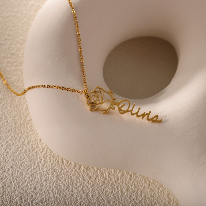 custom name necklace with a detailed rose pendant on a white background